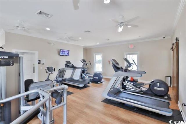 exercise room featuring crown molding, a ceiling fan, a barn door, recessed lighting, and wood finished floors