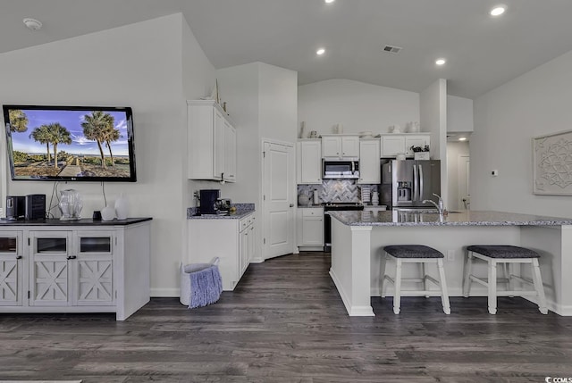 528 Courtridge Loop, Conway, SC 29526 - kitchen with stainless steel appliances, vaulted ceiling, white cabinets, light stone countertops, and a kitchen breakfast bar