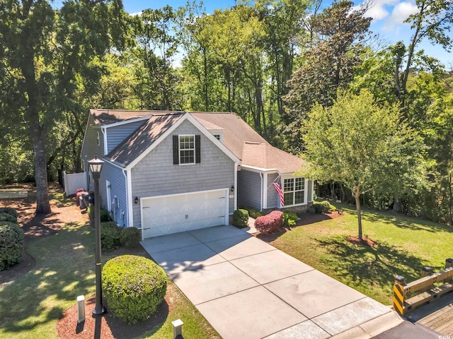 traditional home with driveway, a front lawn, a garage, and a shingled roof