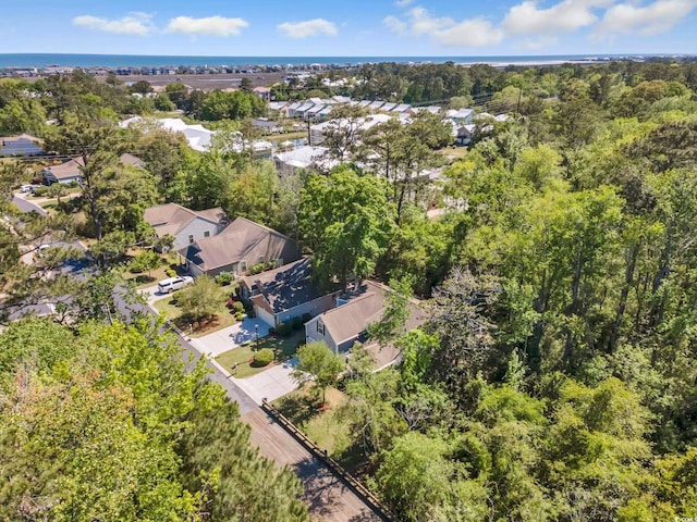 aerial view of residential area featuring a heavily wooded area