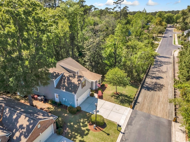 view of subject property featuring a heavily wooded area