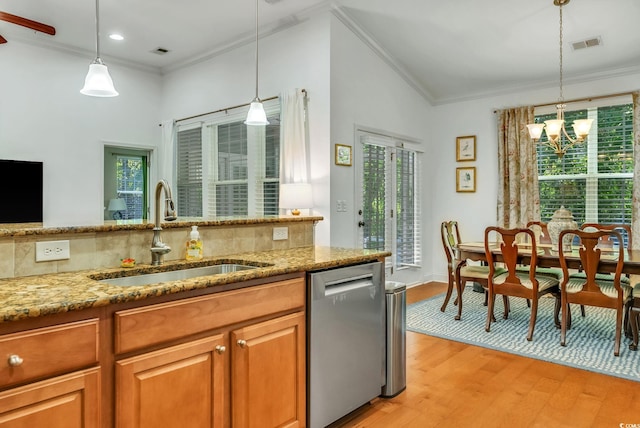 kitchen featuring stainless steel dishwasher, a sink, healthy amount of natural light, crown molding, and recessed lighting