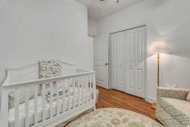 bedroom with wood finished floors and a closet