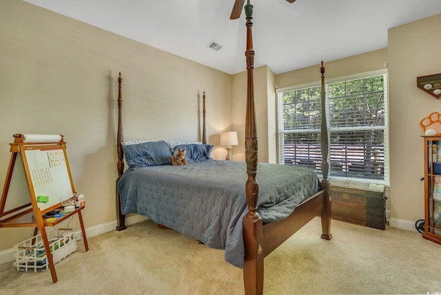 carpeted bedroom with baseboards and a ceiling fan