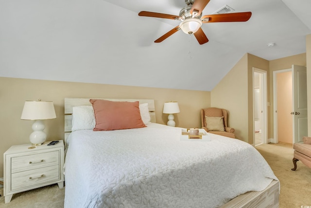 bedroom with light colored carpet, ensuite bath, vaulted ceiling, and a ceiling fan