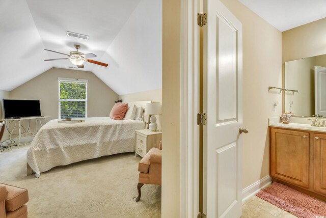 bedroom featuring lofted ceiling, a sink, ceiling fan, and baseboards