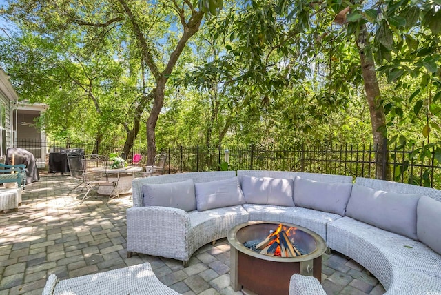 view of patio / terrace with an outdoor living space with a fire pit, a fenced backyard, and grilling area