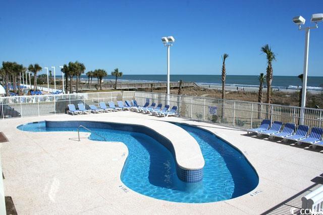 5300 N Ocean Blvd Unit 518, Myrtle Beach, SC 29577 - community pool with fence, a water view, and a patio area