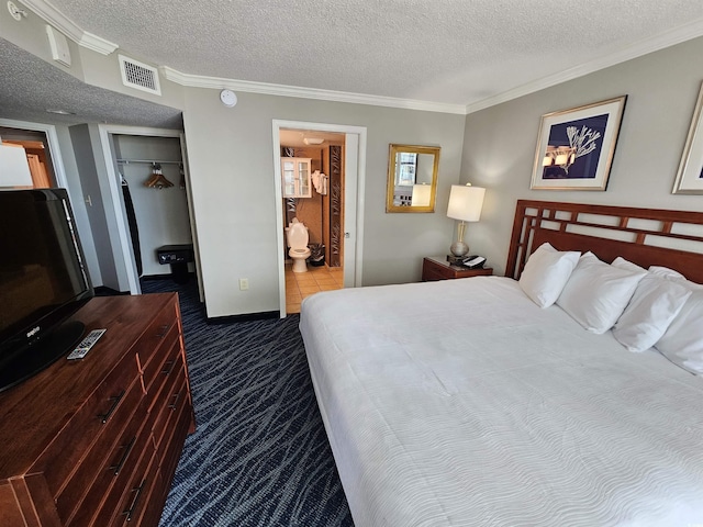 5300 N Ocean Blvd Unit 518, Myrtle Beach, SC 29577 - carpeted bedroom with ornamental molding, a textured ceiling, a closet, ensuite bath, and a walk in closet