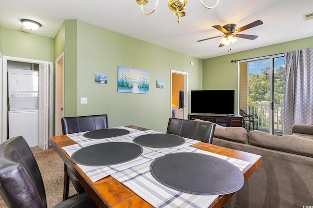 dining area featuring stacked washer / dryer, ceiling fan, and carpet