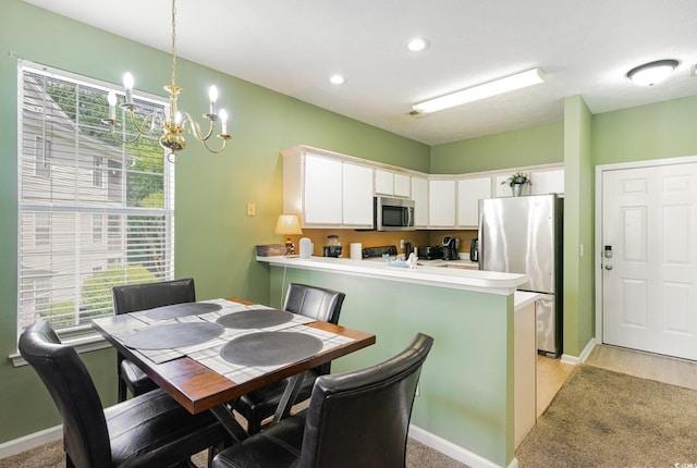 dining space with a chandelier, healthy amount of natural light, recessed lighting, and baseboards