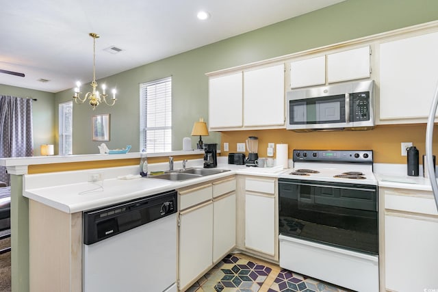kitchen with stainless steel microwave, dishwasher, range with electric stovetop, a peninsula, and a sink
