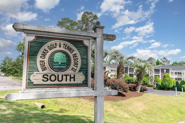 community / neighborhood sign with a lawn
