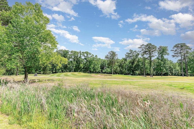 view of tree filled area with golf course view