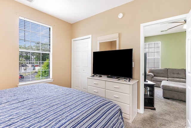 bedroom with light colored carpet and a closet