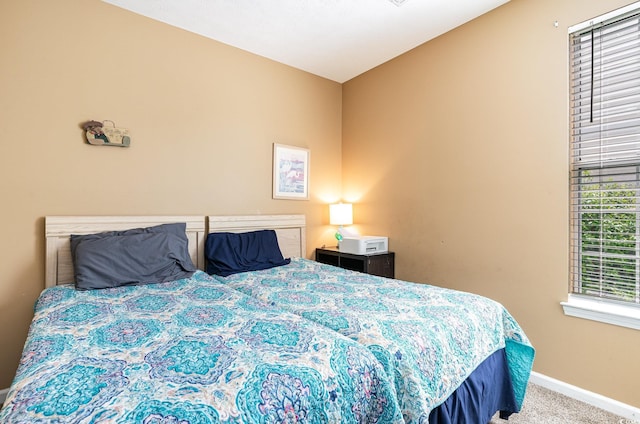 bedroom with baseboards and carpet flooring
