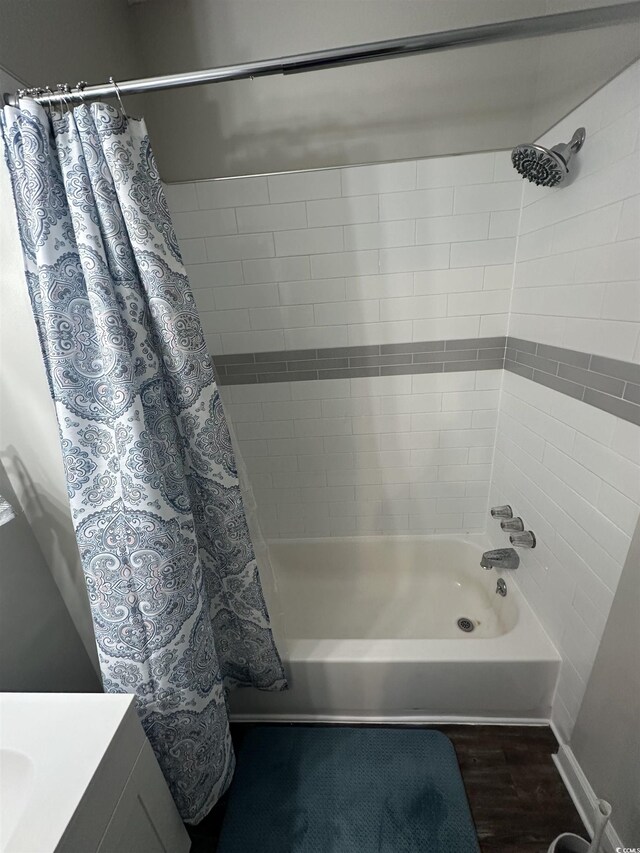 207 E Bobby Gerald Pkwy, Marion, SC 29571 - bathroom with shower / bath combo with shower curtain and wood finished floors