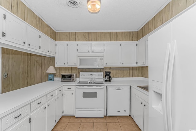 kitchen with white appliances, white cabinets, light tile patterned flooring, light countertops, and a textured ceiling