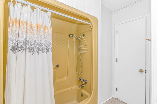 full bathroom featuring tile patterned floors, shower / bath combo with shower curtain, and crown molding
