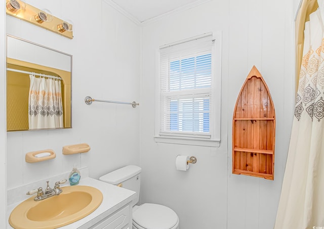 full bathroom with toilet, vanity, and crown molding