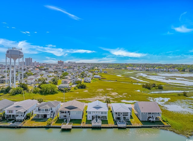 aerial view of residential area featuring a nearby body of water