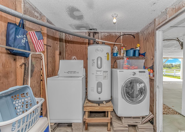 washroom with washer / clothes dryer, electric water heater, a textured ceiling, and wooden walls