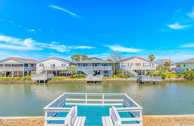 dock area featuring a residential view, a water view, and stairs
