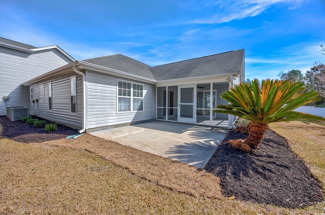 229 Duchess Ct, Myrtle Beach, SC 29588 - rear view of house with a sunroom, a patio area, a shingled roof, a yard, and central AC unit