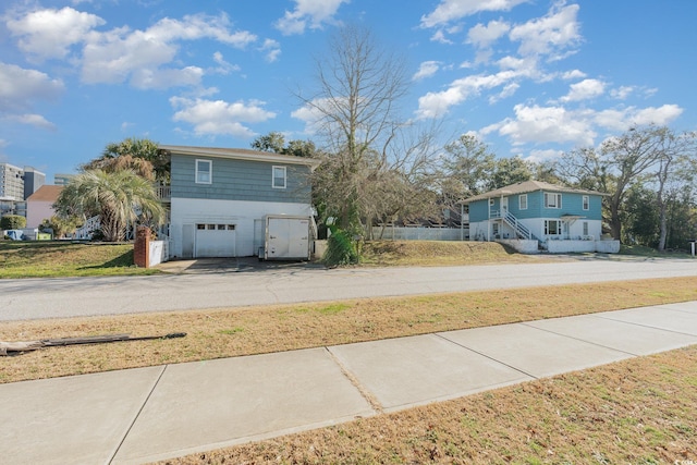 215 28th Ave S, Myrtle Beach, SC 29577 - view of front of house featuring a garage, asphalt driveway, and a front lawn