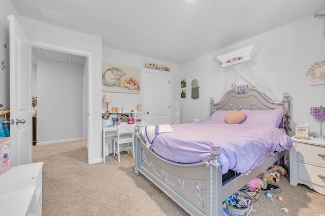 bedroom featuring attic access and light colored carpet