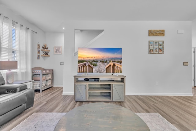 living area with wood finished floors, baseboards, and recessed lighting