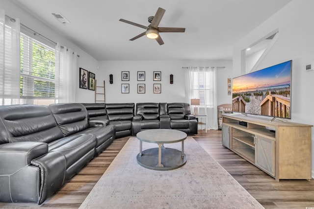 living room featuring wood finished floors and a ceiling fan