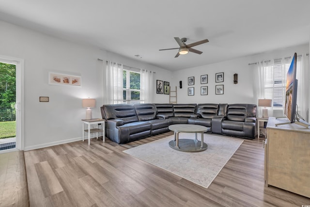 living area featuring a ceiling fan, healthy amount of natural light, and light wood-style floors
