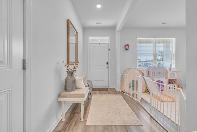 entrance foyer with baseboards, wood finished floors, and recessed lighting