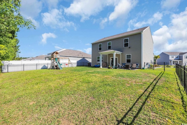 rear view of house featuring a playground and a patio