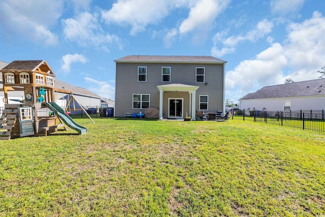 rear view of house featuring a playground