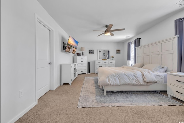bedroom featuring light colored carpet, baseboards, and ceiling fan