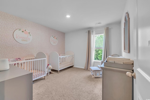 bedroom featuring a nursery area, wallpapered walls, baseboards, carpet floors, and recessed lighting