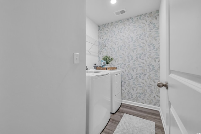 laundry room featuring wallpapered walls, washing machine and clothes dryer, wood finished floors, baseboards, and recessed lighting