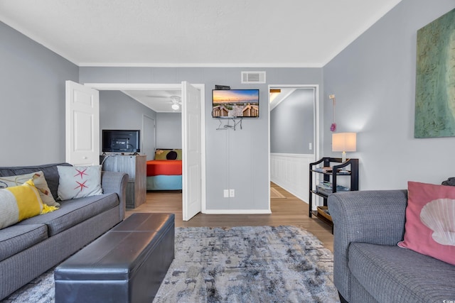 9400 Shore Dr Unit 206, Myrtle Beach, SC 29572 - living room featuring wood finished floors, crown molding, and a wainscoted wall