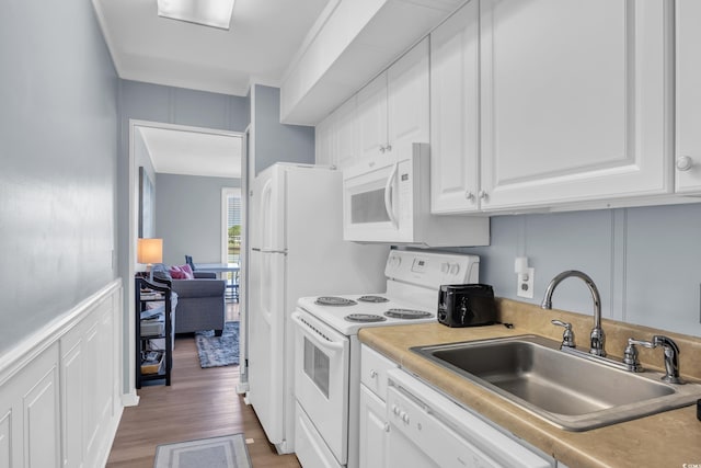 9400 Shore Dr Unit 206, Myrtle Beach, SC 29572 - kitchen featuring white appliances, a sink, white cabinets, light wood finished floors, and light countertops