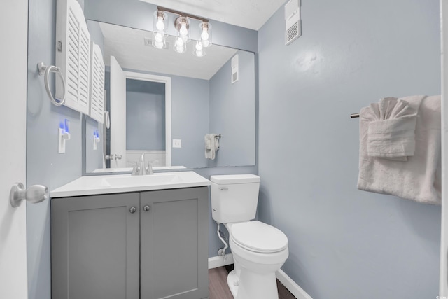 9400 Shore Dr Unit 206, Myrtle Beach, SC 29572 - half bath with toilet, vanity, wood finished floors, and baseboards