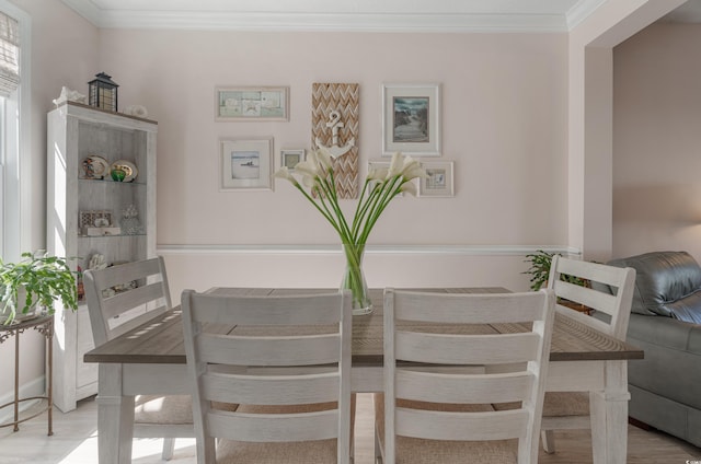 dining room featuring crown molding and wood finished floors