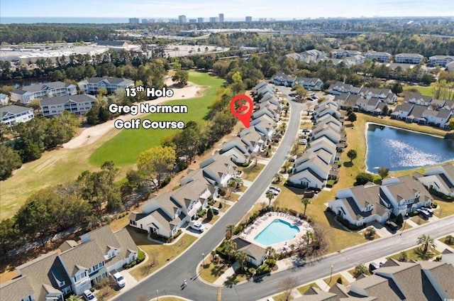 aerial overview of property's location with nearby suburban area, a pool area, and a large body of water