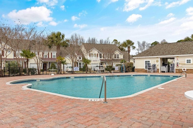 community pool featuring fence and a patio