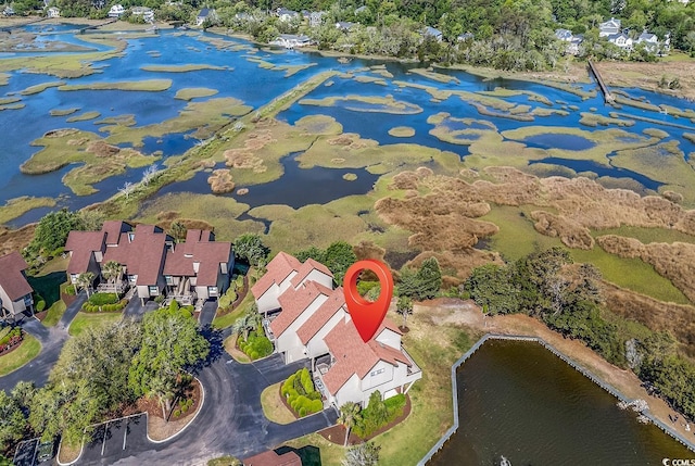aerial view of property and surrounding area featuring a nearby body of water