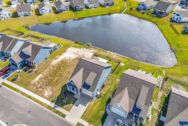 aerial perspective of suburban area featuring a nearby body of water