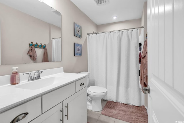 bathroom featuring toilet, vanity, tile patterned flooring, and a shower with curtain