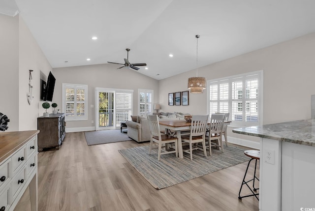 dining space featuring light wood-style floors, lofted ceiling, baseboards, a ceiling fan, and recessed lighting