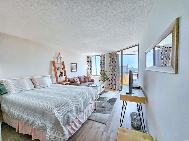 9650 Shore Dr Unit 1203, Myrtle Beach, SC 29572 - bedroom featuring wood finished floors and a textured ceiling